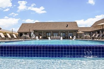 a swimming pool with a building in the background at Upland Flats, Colorado, 80922